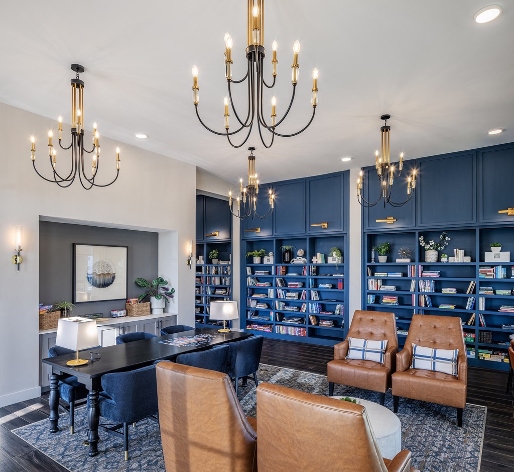 a living room with a table and chairs and chandeliers