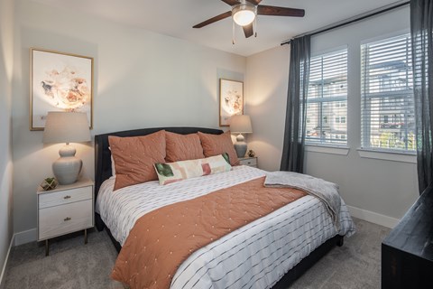 a bedroom with a ceiling fan and a queen sized bed at a senior