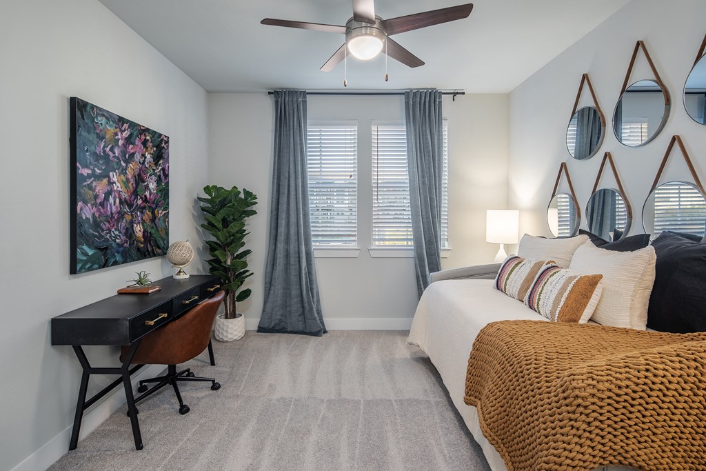 a bedroom with a large bed and a ceiling fan