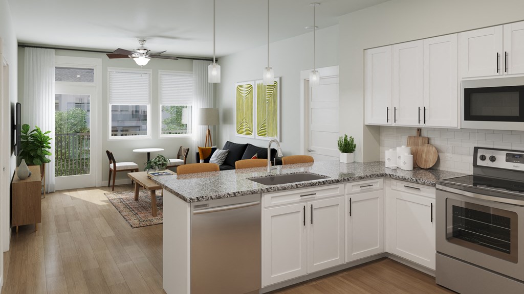 a kitchen and living room with white cabinets and a counter top
