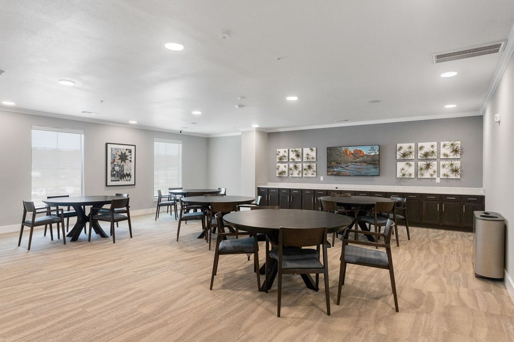a community clubhouse small dining area with tables and chairs at a senior apartment community
