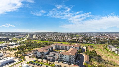 an aerial view of a senior apartment community and surrounding land