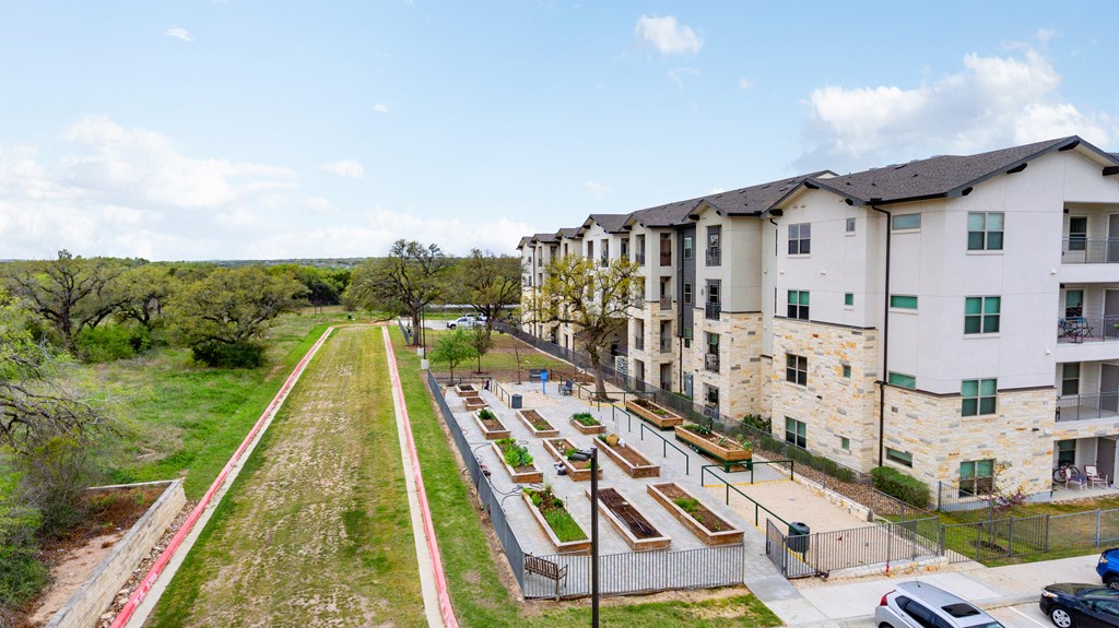 an aerial view of an apartment complex with grass and trees