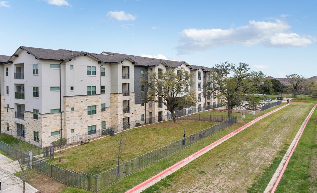 an aerial view of an apartment complex with grass and trees