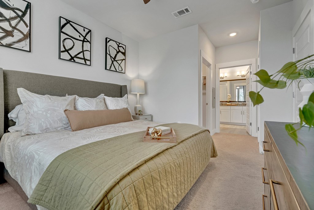 a bedroom with a large bed and a bathroom