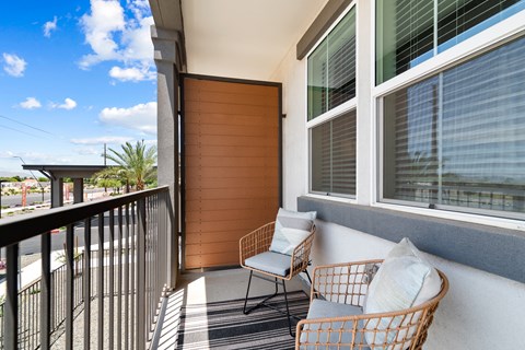 A balcony with a chair and a table.
