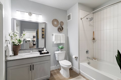A white bathroom with a sink, toilet, and bathtub.