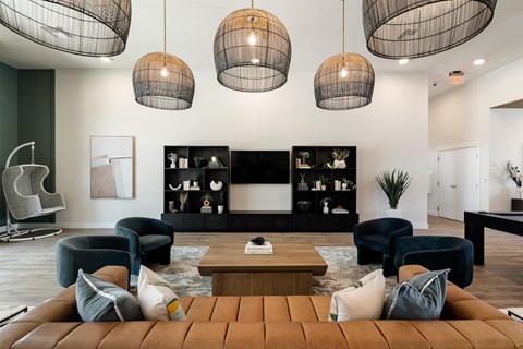 A living room with a brown leather sofa and a wooden coffee table.