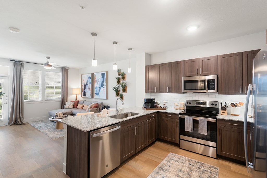 an open kitchen and living room with a couch and