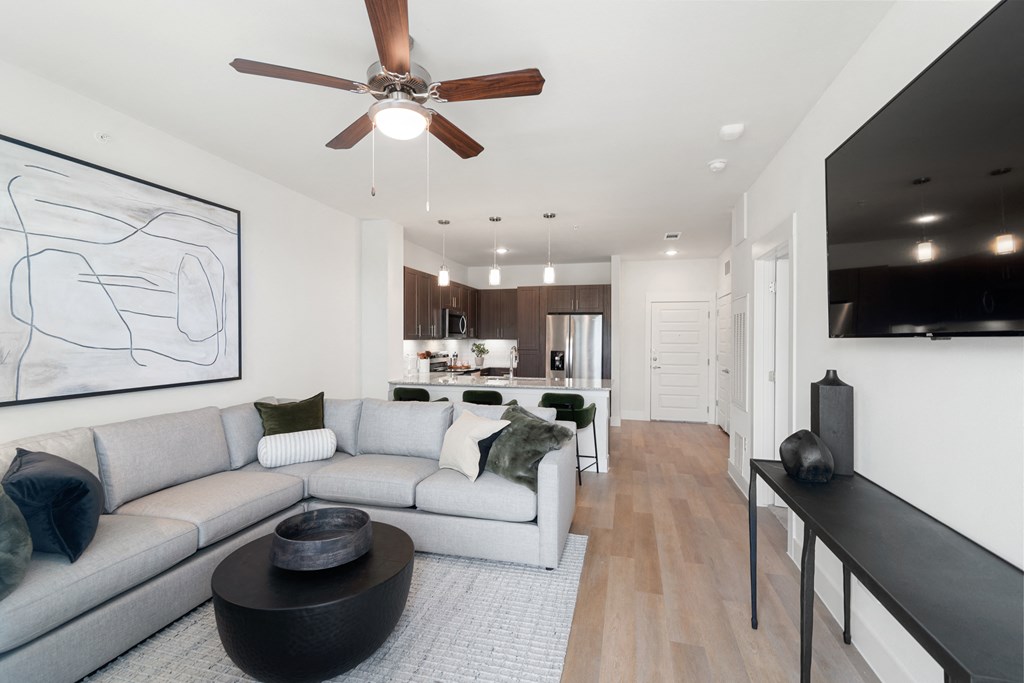 a living room with a couch and a ceiling fan