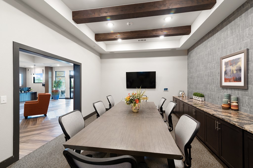 a dining room with a wooden table and chairs