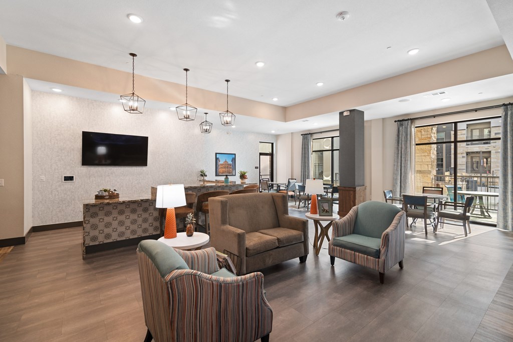 a living room with couches and chairs and a television