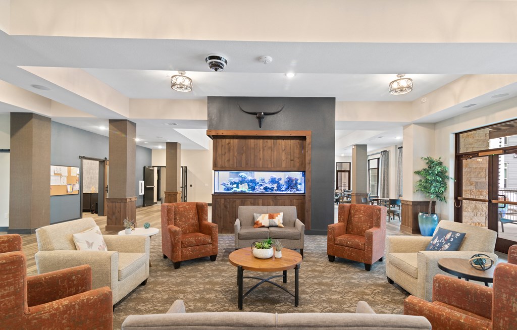 a lobby with couches and chairs and a fireplace