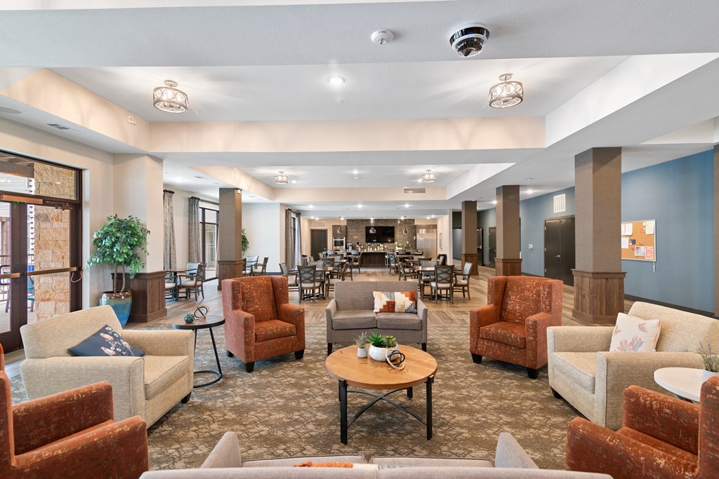 a large lobby with couches and chairs and a table