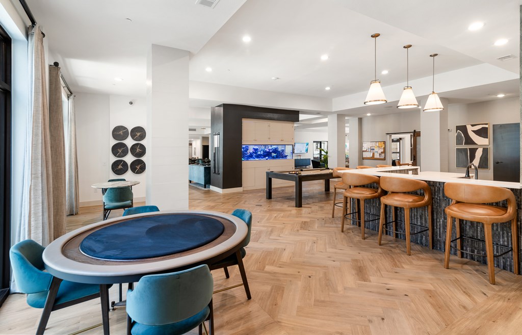 A modern dining room with a blue table and chairs.