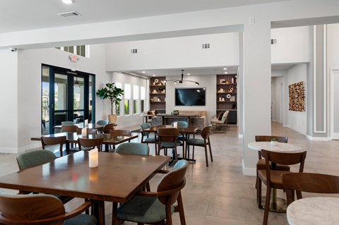 a dining room with tables and chairs and a television