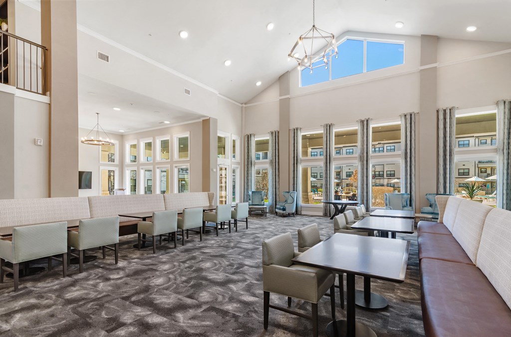 a large dining room with tables and chairs and windows