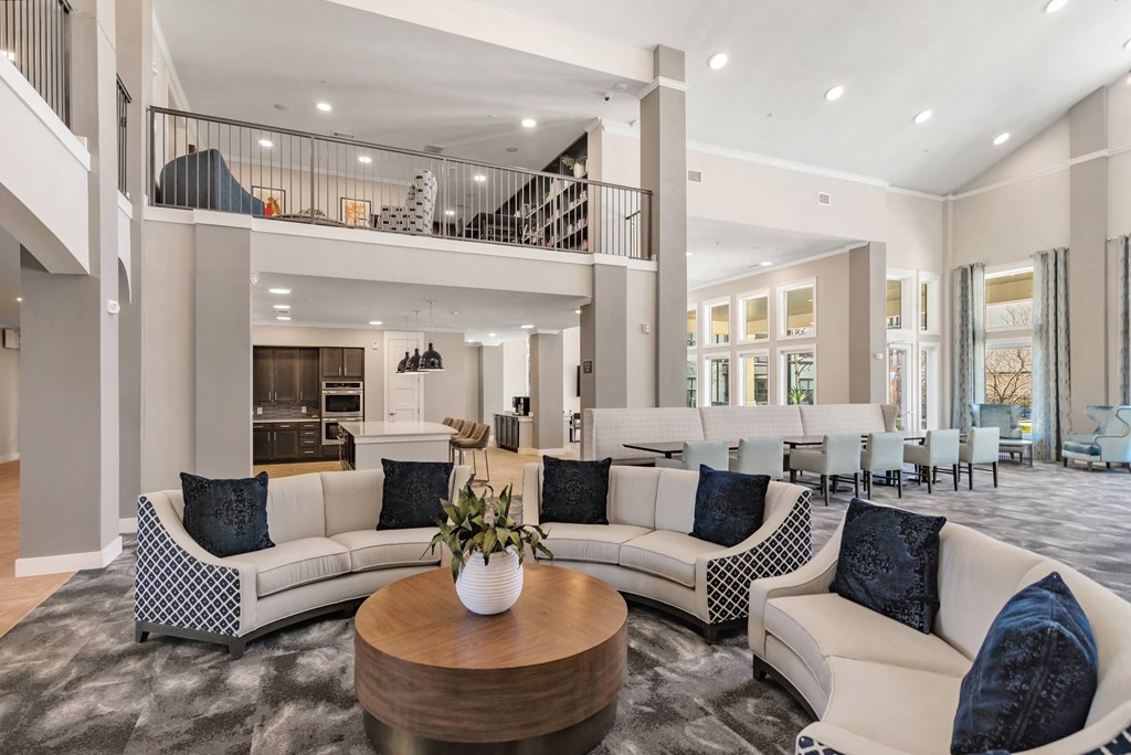 a living room with couches and chairs and a table