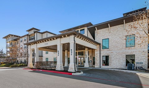 an exterior view of the main entrance to a senior apartment community