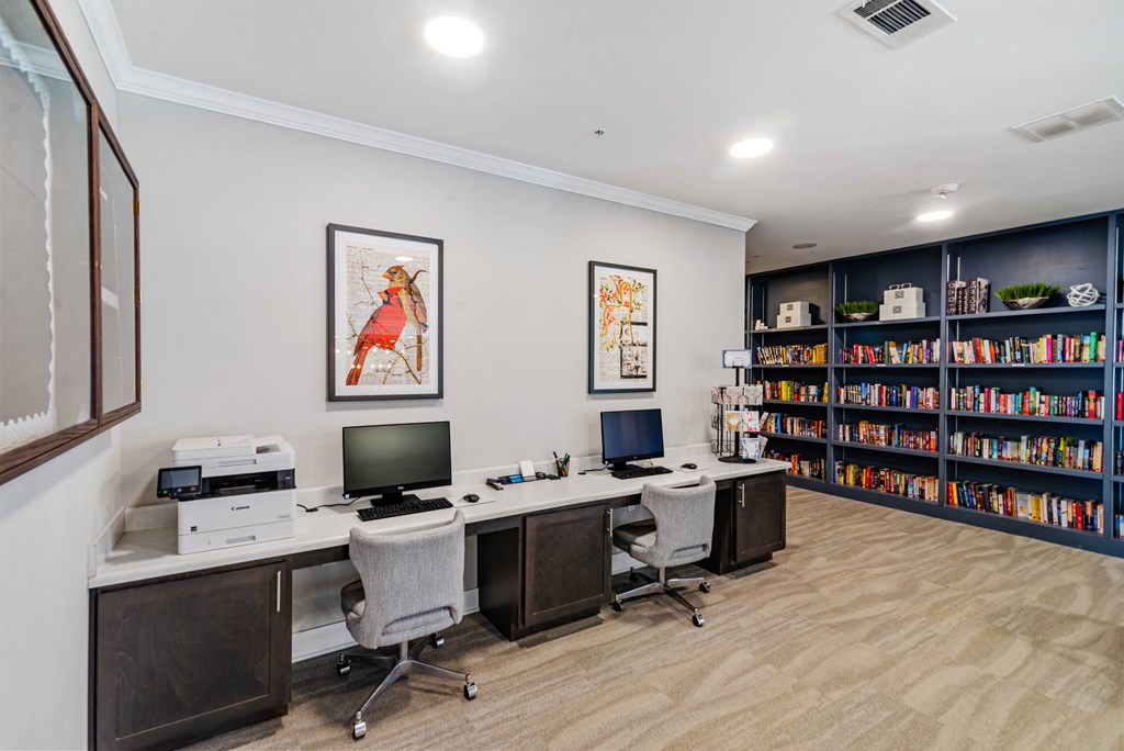 the preserve at ballantyne commons library with two computers and a bookshelf