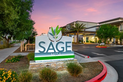 the sign for sage mesa at sunset in front of the entrance to the complex