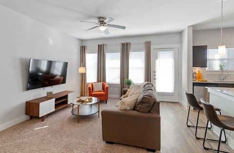 a living room with a couch and a ceiling fan