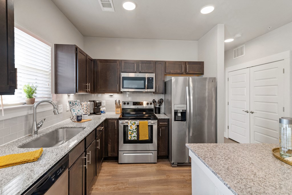 a kitchen with stainless steel appliances and granite counter tops