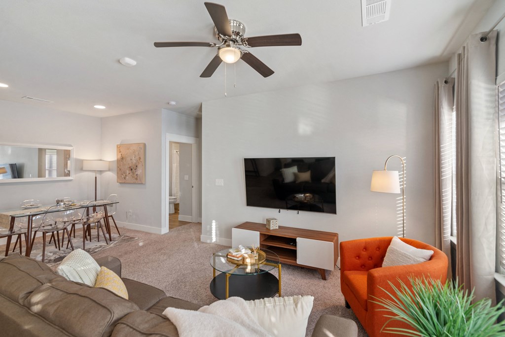a living room with a couch and a ceiling fan