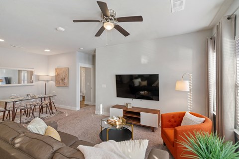 a living room opening up to a kitchen at a senior apartment community