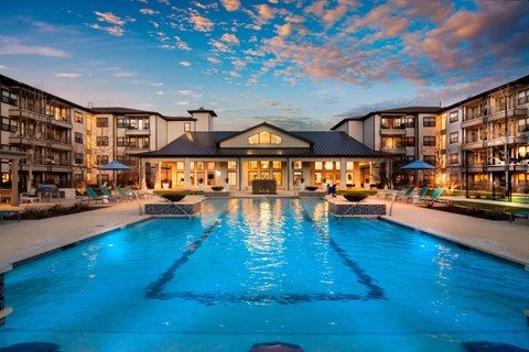 a resort-style pool and patio area at a senior apartment community