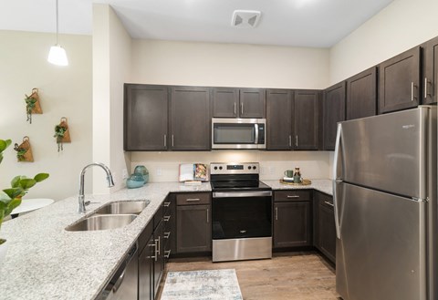 a kitchen with stainless steel appliances and granite counter tops