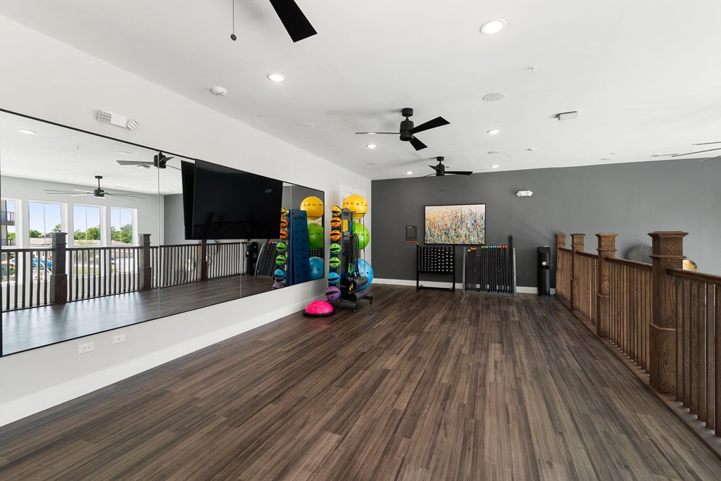 a game room with a large screen tv and a pool table