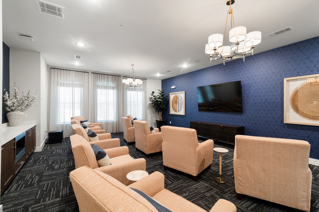 a lounge room with chairs and a television