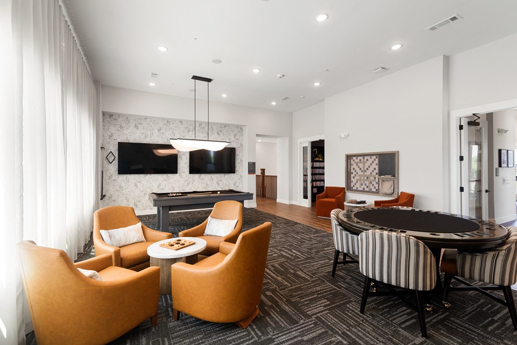 a living room with a round table and chairs and a television