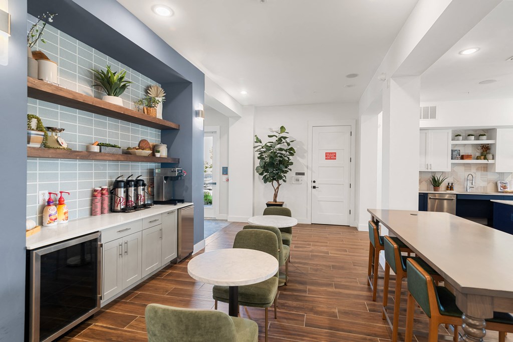 a dining room with a table and chairs and a kitchen