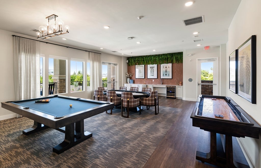 A room with a pool table and a couch.
