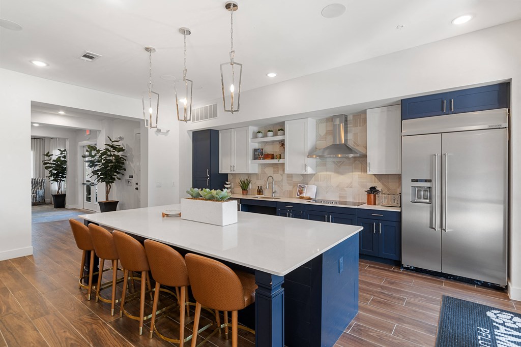 a blue and white kitchen with stainless steel appliances and a white counter top