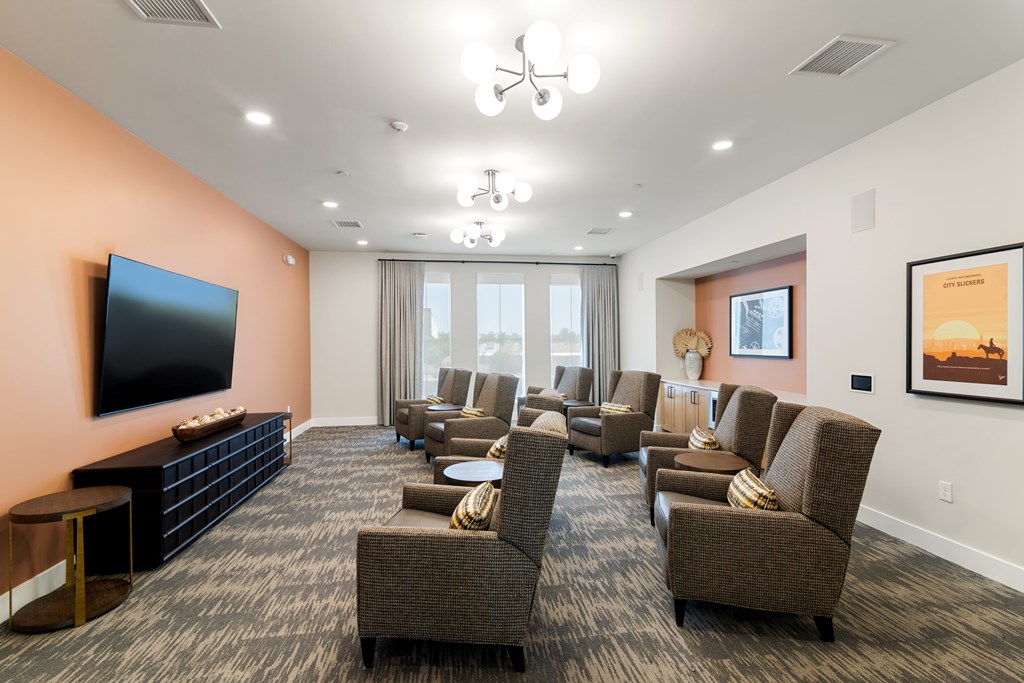 A living room with a large couch and a television on the wall.