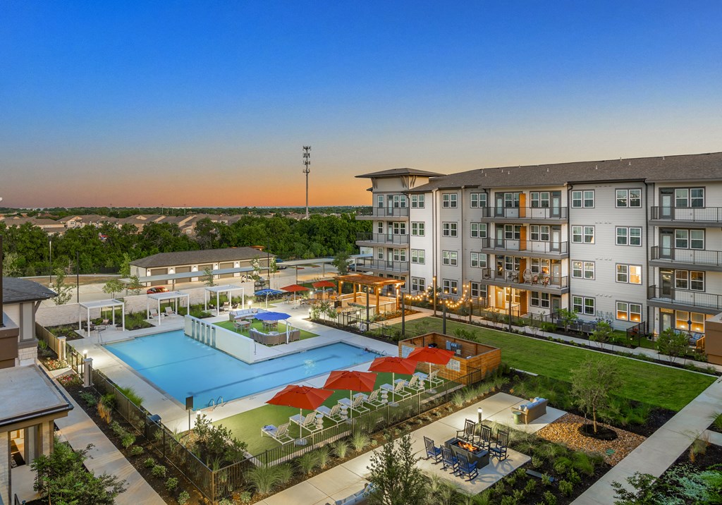 an aerial view of an apartment complex with a large swimming pool