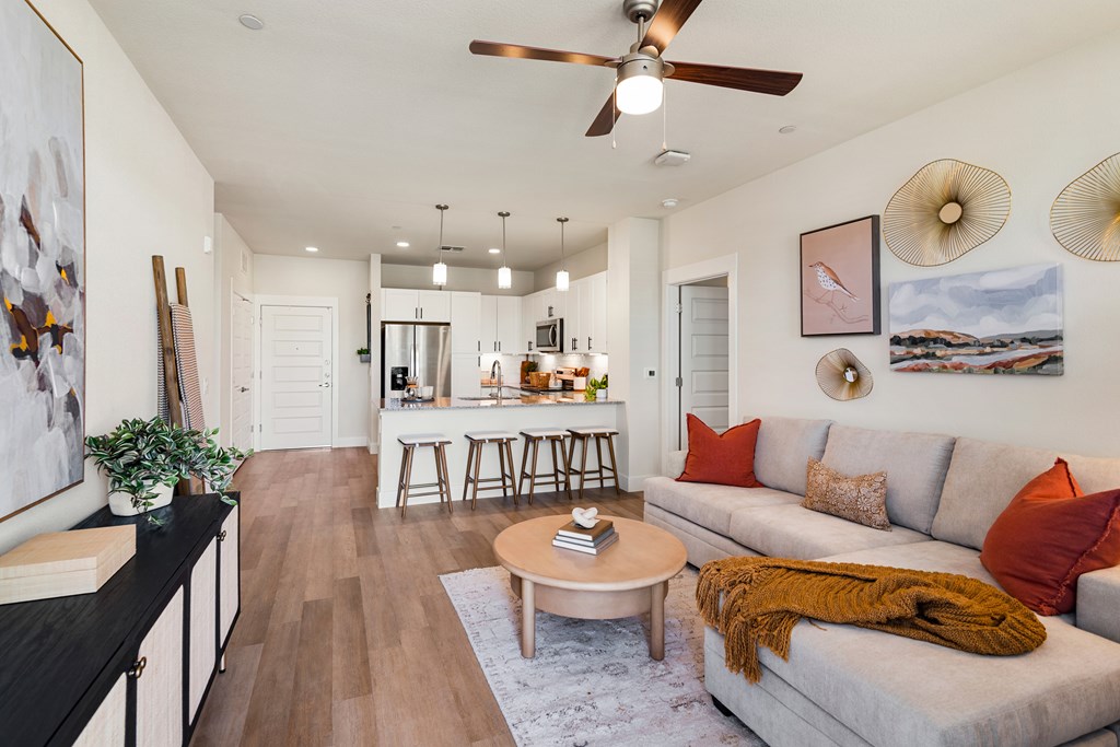 A living room with a grey couch and a coffee table.