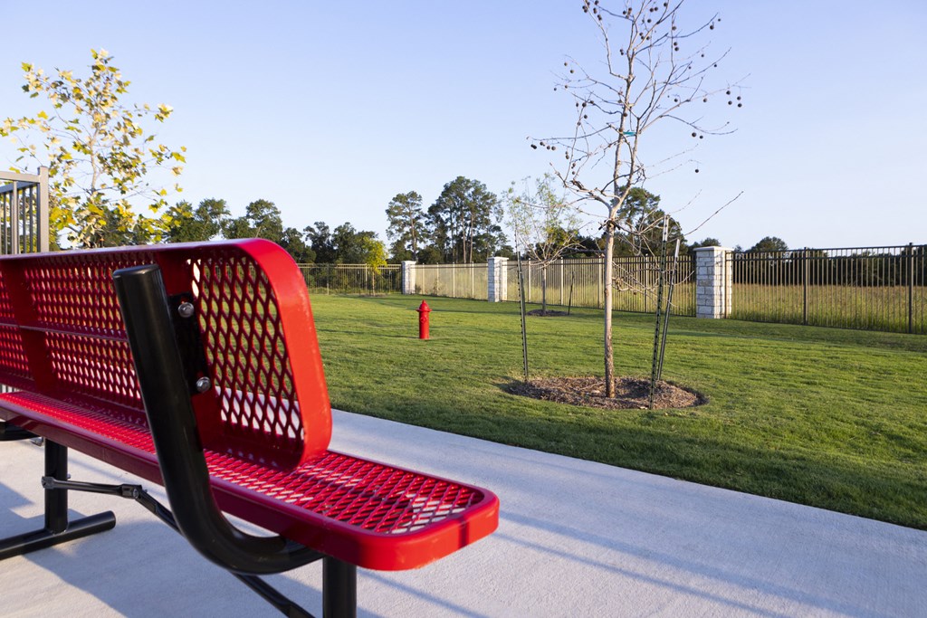a dog park with benches at a senior apartment community