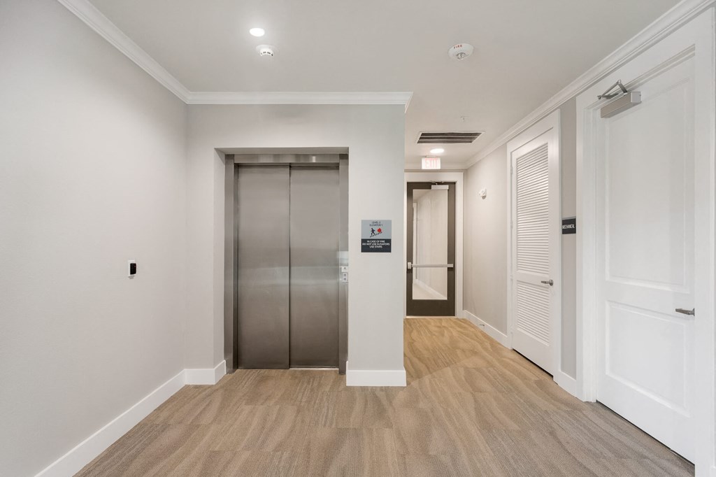 an elevator in a hallway at a senior apartment community