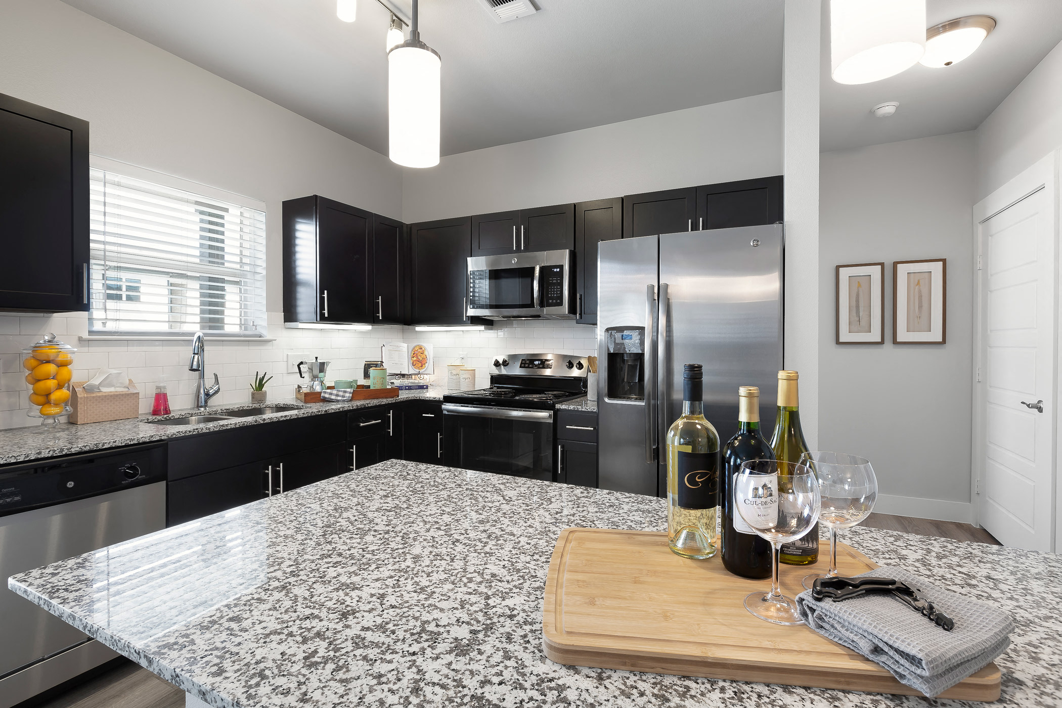Espresso cabinetry and granite countertops at Solea Cedar Park Senior Apartments in Cedar Park Texas