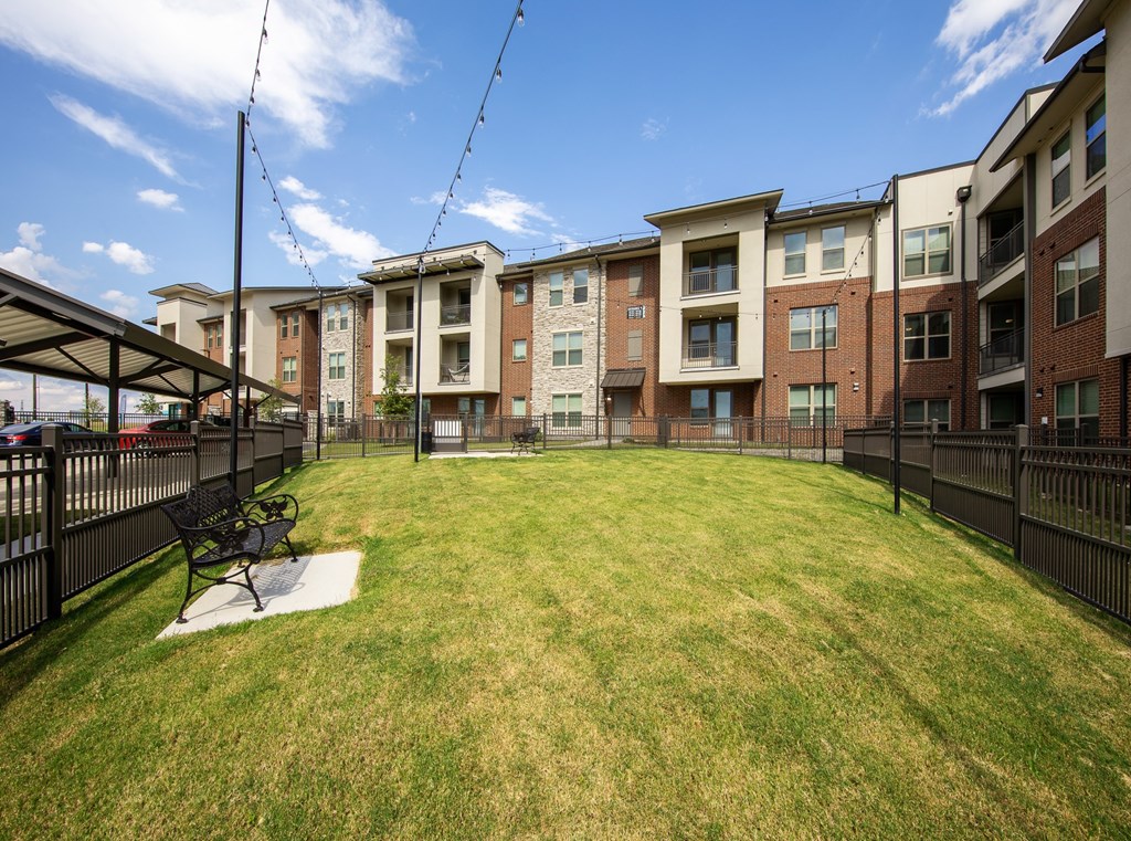 a fenced in dog park at a senior apartment community