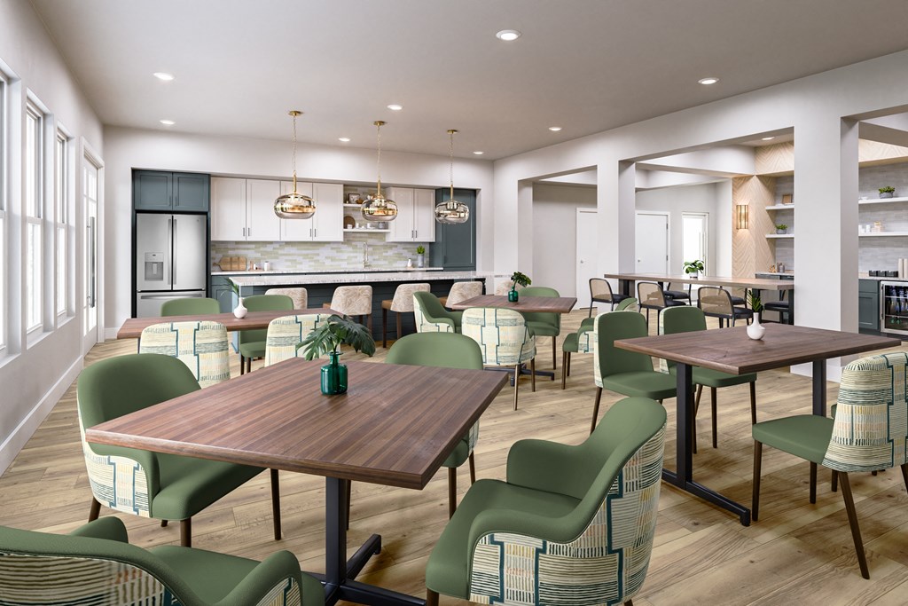 a restaurant with tables and chairs and a kitchen in the background