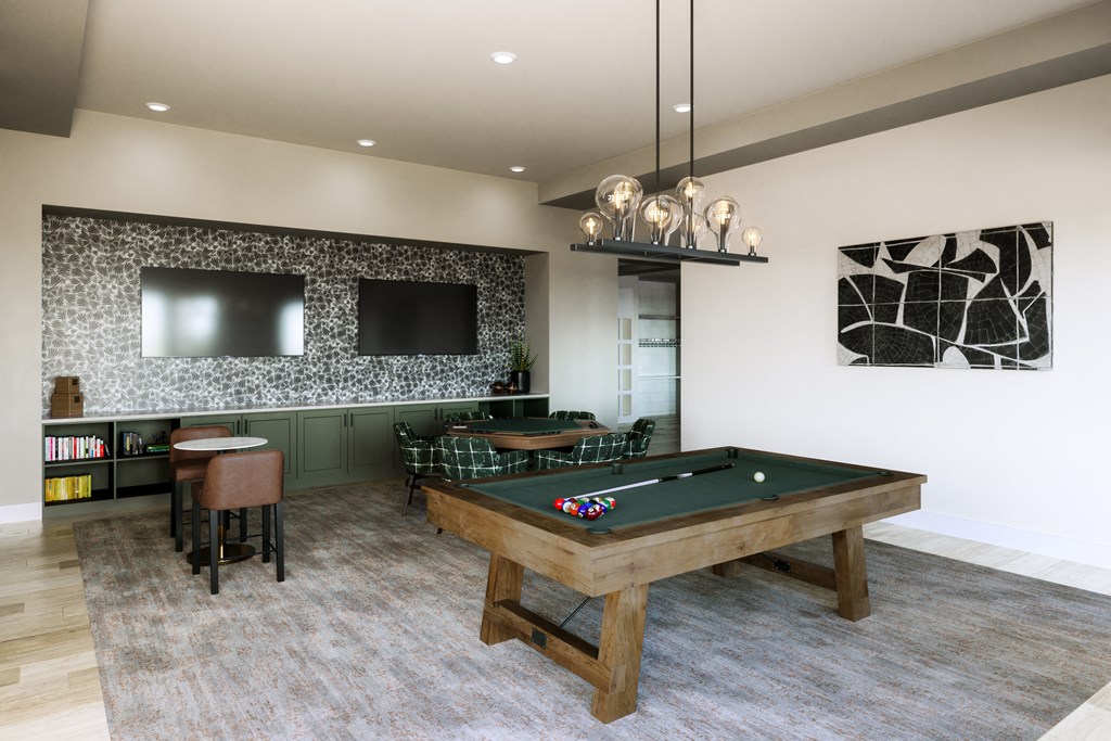 a games room with a pool table and two televisions