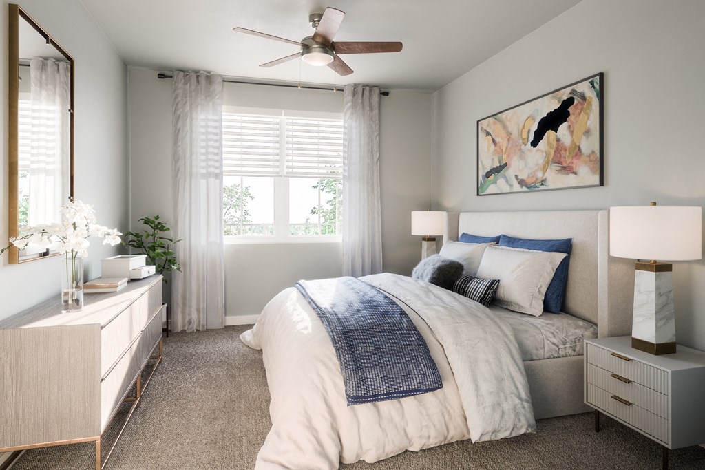 a bedroom with a large bed with white bedding and a large painting on the wall