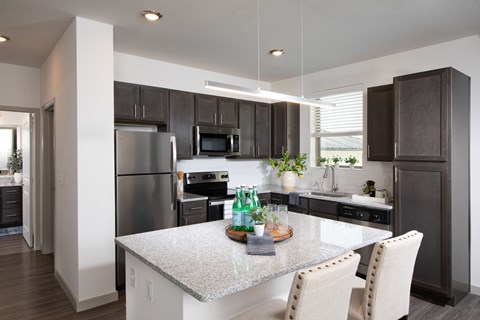 a kitchen with stainless steel appliances and a granite counter top