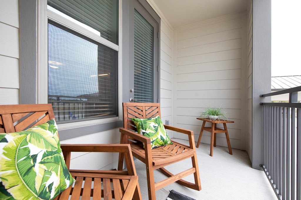 a private patio with a sitting area at a senior apartment community