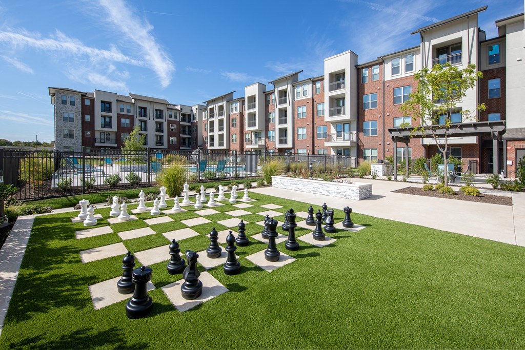a large chess set in the middle of an apartment complex